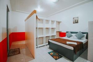 a bedroom with a bed with red and white walls at RB Modern Condos in Zamboanga