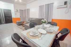 a dining table and chairs in a living room at RB Modern Condos in Zamboanga