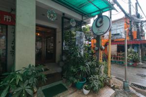 a building with a bunch of plants in front of it at Catlea Inn in Manila