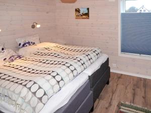 a bedroom with a large bed in a room at 8 person holiday home in Åram in Sandvik