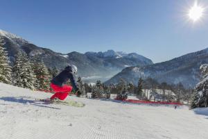 a person is skiing down a snow covered slope at Apartment in Achenkirch with a garden in Achensee