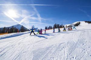 a group of people skiing down a snow covered slope at Apartment in Achenkirch with a garden in Achensee