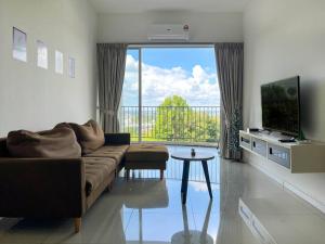 a living room with a couch and a large window at Taiping City View Condo near Lake Garden/ Netflix in Taiping