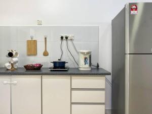 a kitchen with a counter with a blender and a refrigerator at Taiping City View Condo near Lake Garden/ Netflix in Taiping