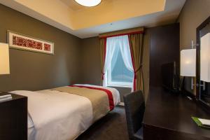 En eller flere senge i et værelse på Hotel Monterey Akasaka