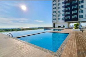 a swimming pool in front of a building at Biubiu Home in Melaka