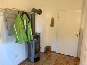 a green jacket hanging on a rack in a room at Ferienwohnung "Fichtelnaabrauschen" in Fichtelberg