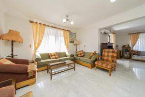 a living room with couches and chairs and a table at Flat with Balcony 3 min to Fosforlu Beach in Antalya