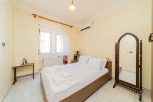 a bedroom with a large bed and a mirror at Flat with Balcony 3 min to Fosforlu Beach in Antalya