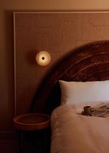 A bed or beds in a room at Swell Hotel Byron Bay - Adults Only