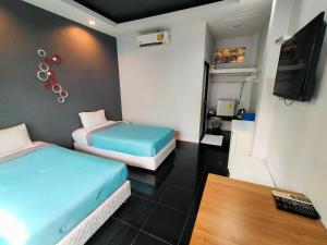 a hotel room with two beds and a television at Nemo 2 Resort in Ao Nang Beach