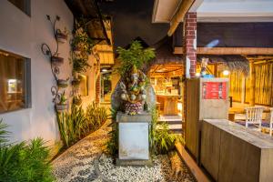 a statue of an elephant in a room with plants at The Nest Canggu in Canggu