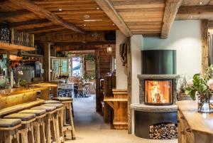 a restaurant with a fireplace in the center of the room at Schrannenhof in Schoppernau