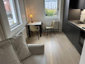 a living room with a couch and a table and two chairs at Apartment in Sollentuna Centrum 1205 in Sollentuna +13 photos