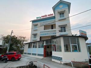 a white building with a sign on it at Phước Hưng 1 Hotel in Vĩnh Long