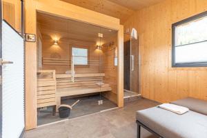 a room with a sauna in a wooden cabin at Almdorf Hohentauern by ALPS RESORTS in Hohentauern