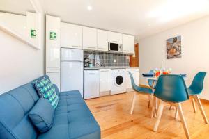 a living room with a blue couch and a table at Alfama Charming Apartment in Lisbon