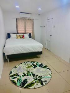 a bedroom with a bed and a rug on the floor at HomeStay Private Home in Suva