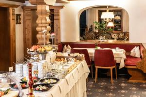 a buffet line with plates of food in a restaurant at Hotel Elisabeth in Schoppernau
