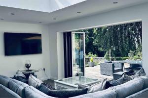 a living room with a couch and a glass table at Stunning 3-Bed Cottage in Gateshead in Gateshead