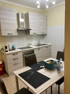 a kitchen with a table and a sink and a counter at Bicocca Flat F in Milan