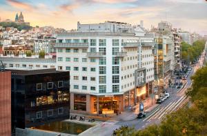 a large white building on a city street at INNSiDE by Meliá Barcelona Apolo in Barcelona