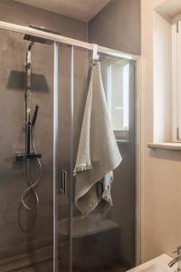 a shower stall with a towel hanging on the wall at I Ciabot di Monforte in Monforte dʼAlba