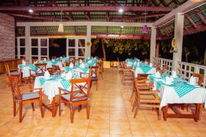 a group of tables and chairs with blue and white tablecloths at Mandarin Resort Zanzibar in Kizimkazi