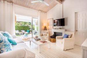 a living room with a white couch and chairs at Casa Bambou An hidden gem near Saint Tropez with private pool in Gassin