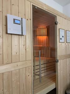a wooden sauna with a television in a room at My Baltic Sea - Ferienwohnungen im Seaside House in Scharbeutz