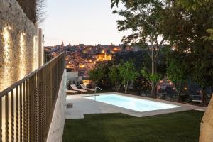 a swimming pool in the backyard of a house at Giardino Sul Duomo in Ragusa