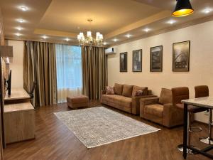 a living room with a couch and a table at CITY STAY Апарт-Отель Алматы in Almaty