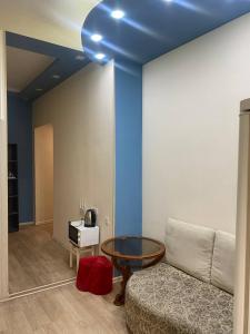 a living room with a couch and a blue ceiling at Paronyan hostel in Yerevan