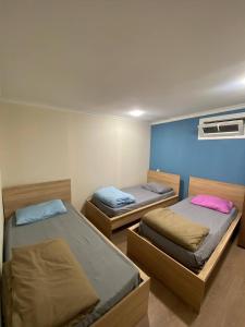 a room with two beds and a wall at Paronyan hostel in Yerevan