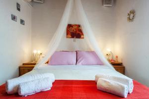 a bedroom with a bed with a mosquito net at Karavos Sea View Apartments in Skopelos Town