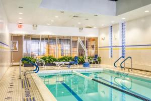 a swimming pool in a building with a swimming pool at UES 1BR w Gym WD nr Central Park NYC-1296 in New York