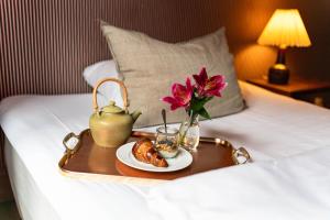 Un ou plusieurs lits dans un hébergement de l'établissement Rye115 Hotel