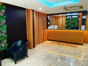 a waiting room with a cash register and a chair at Cozy Hotel@ KL Sentral in Kuala Lumpur