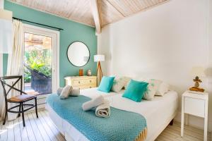 a bedroom with a bed and a chair and a mirror at Casa Bambou An hidden gem near Saint Tropez with private pool in Gassin +54 photos