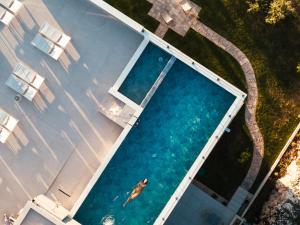 an overhead view of a swimming pool with a man in the water at Boutique hotel MaViE - Adults Only in Neum