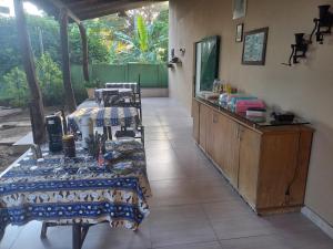 a kitchen with two tables and a counter in a room at Pousada Rural Veredas in Três Marias