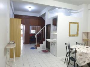 a dining room with a table and a sink at 7/7 House, Classic House for family in Hat Yai
