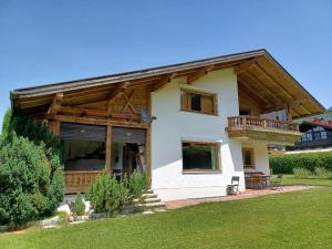 a house with a porch and a balcony at Alpen-Chalet Benzeck in Reit im Winkl