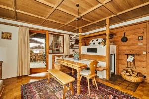 a dining room with a wooden table and chairs at Alpen-Chalet Benzeck in Reit im Winkl