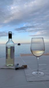 eine Flasche Wein und ein Glas Wein auf dem Tisch in der Unterkunft Casa Francesca in Stromboli