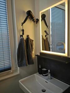 a bathroom with a sink and a mirror at Z8 Living in Hannover