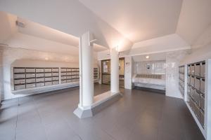 a large hallway with white columns in a building at Westhinder 200m From Sea - Happy Rentals in De Panne