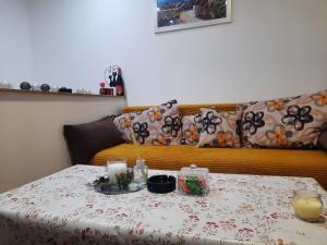 a table with a flowered table cloth on a couch at Mace MM :) in Šabac