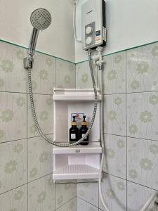 a shower in a bathroom with a shower head at Lanta L.D. Beach Bungalow in Ko Lanta