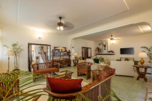 a living room with chairs and a couch at ama Stays & Trails Skanda , Coorg in Madikeri